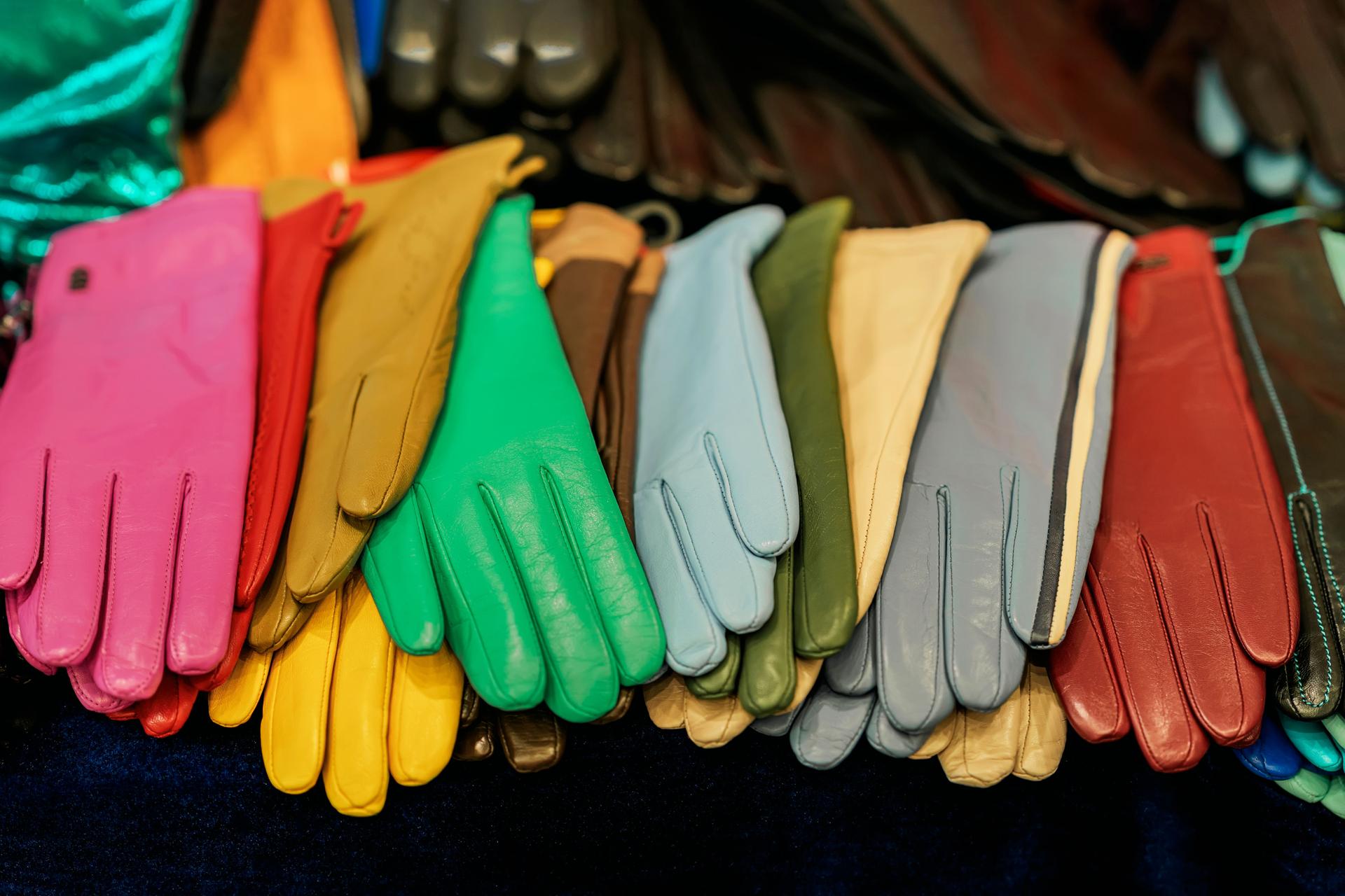 Set of colorful leather gloves on dark background