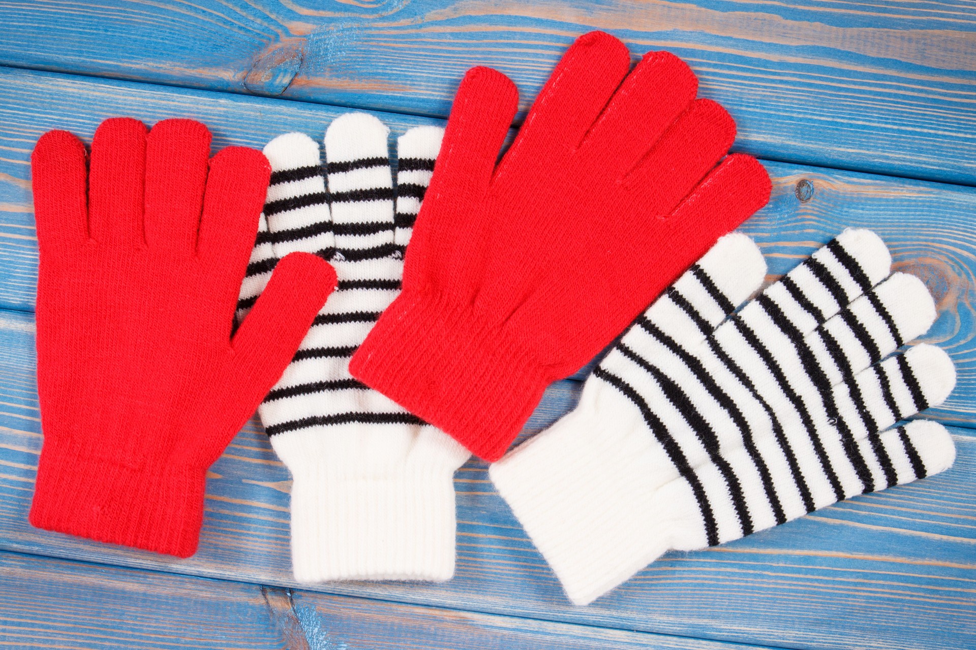 Red and striped womanly gloves for autumn or winter