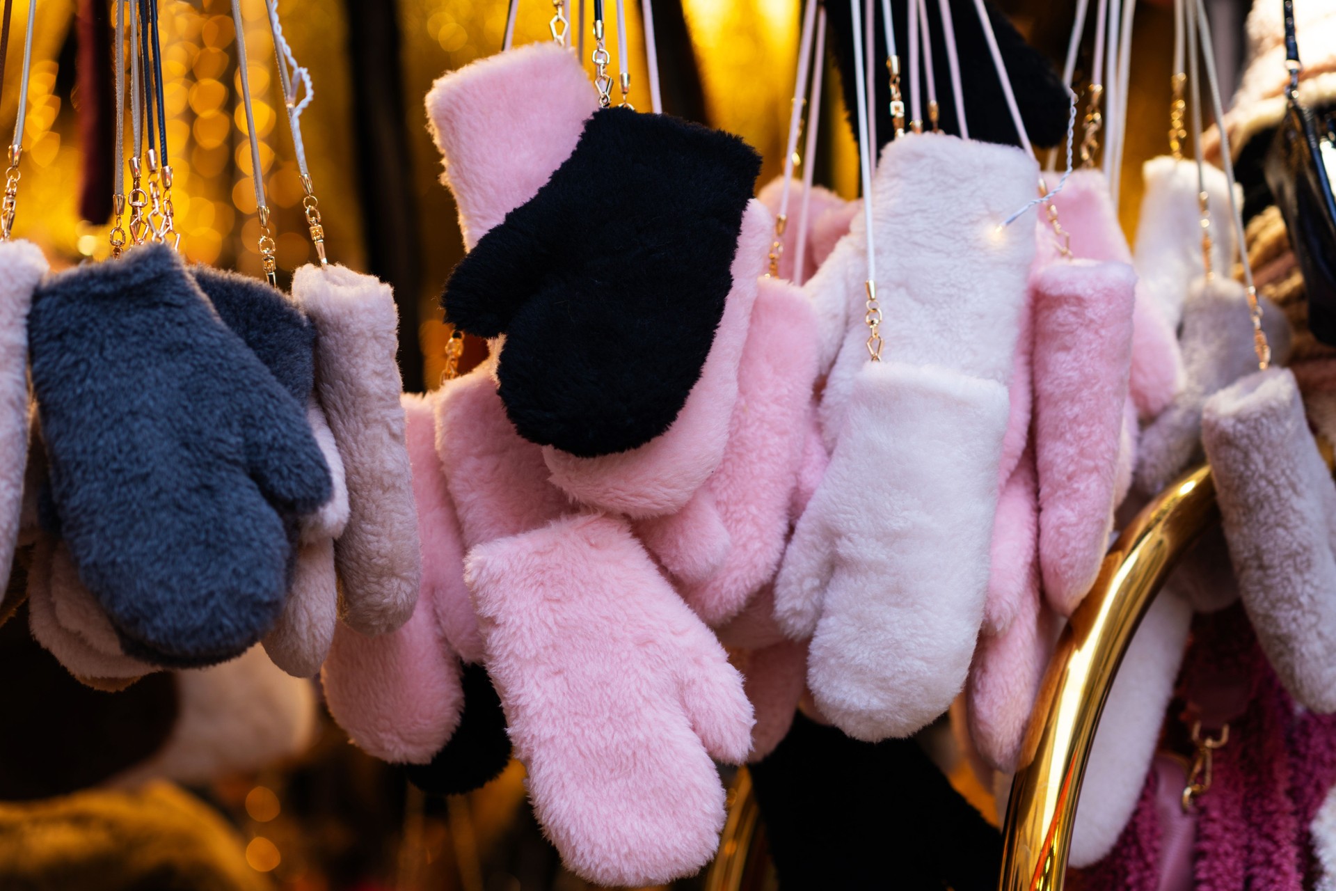 Soft Winter Mittens in Various Colors Hanging on Display